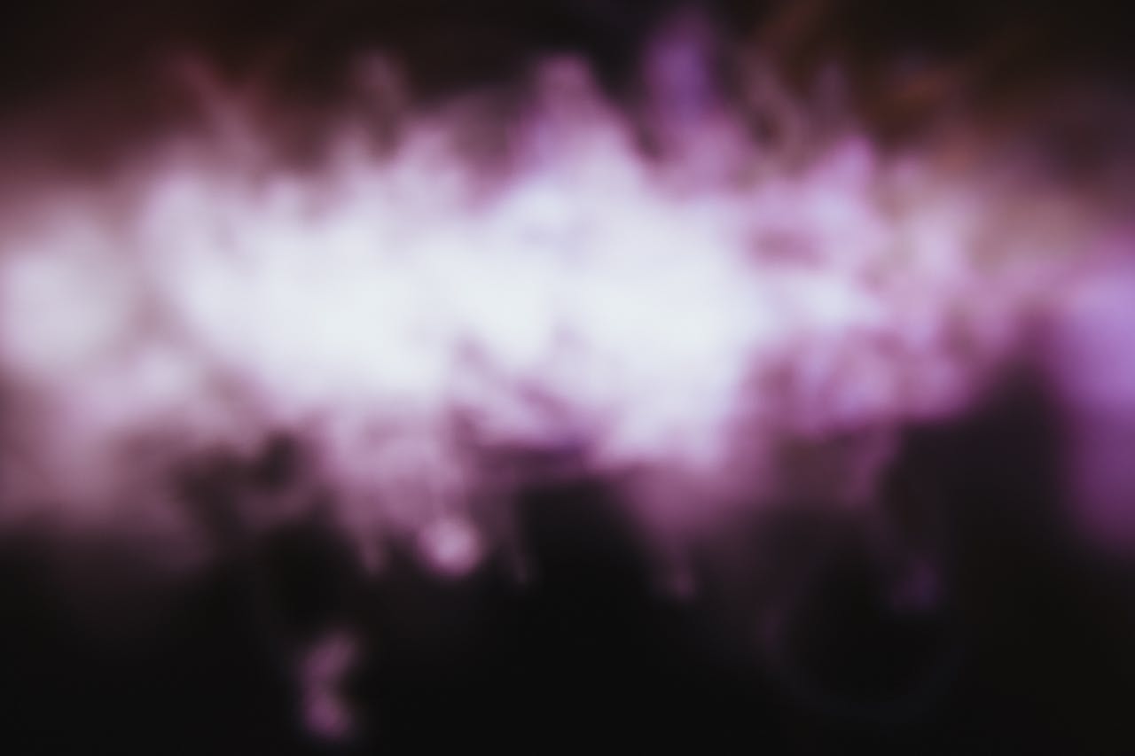 Ethereal purple blurred abstract background with a mysterious aura and soft haze.